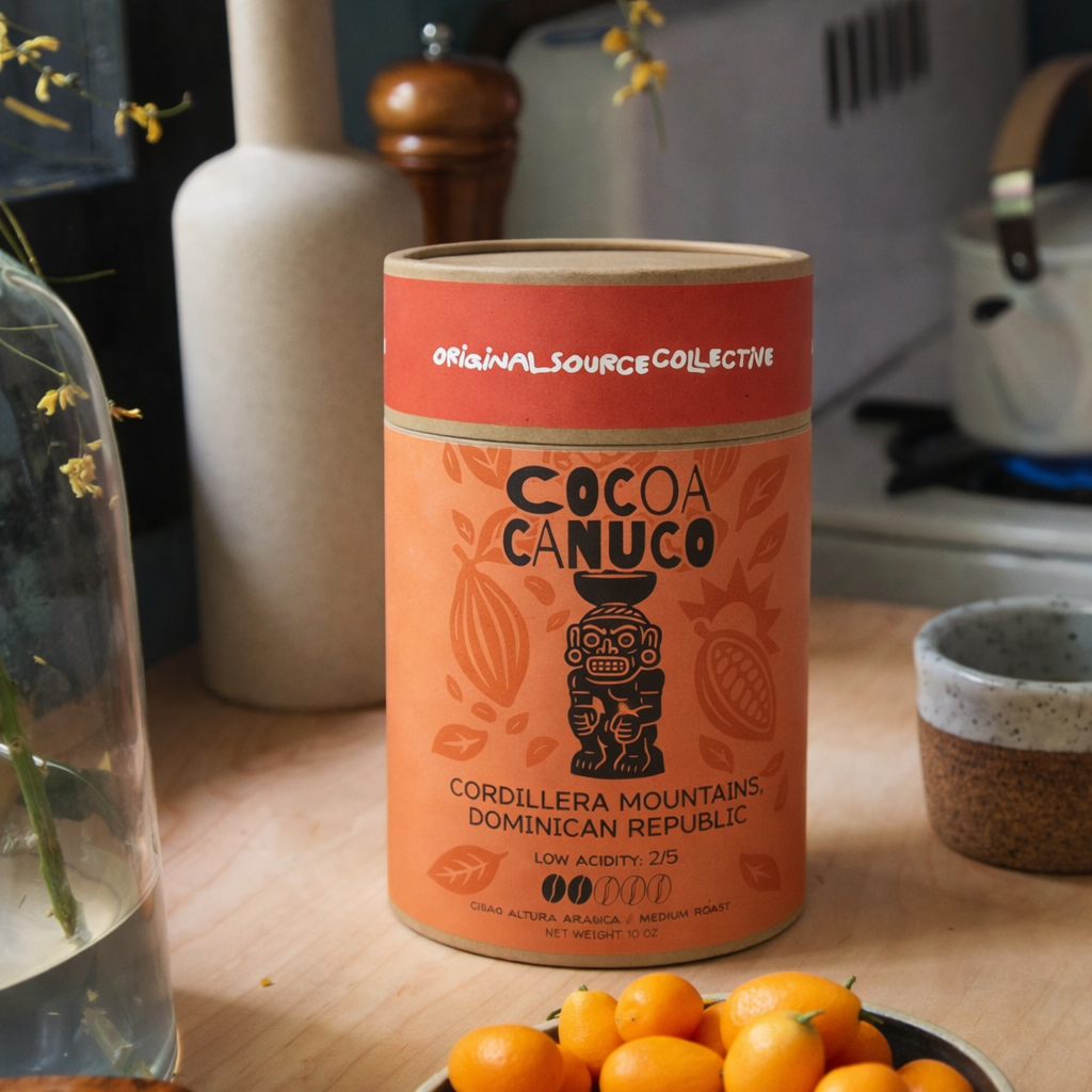 Cocoa Canuco container in a kitchen on a wooden surface with decorative items in the background